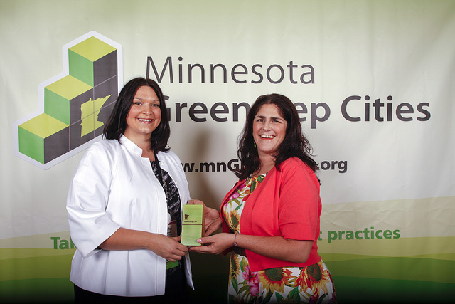 Jennifer Hassebroek, Senior Community Development Specialist with the City of Oakdale, accept their GreenStep award